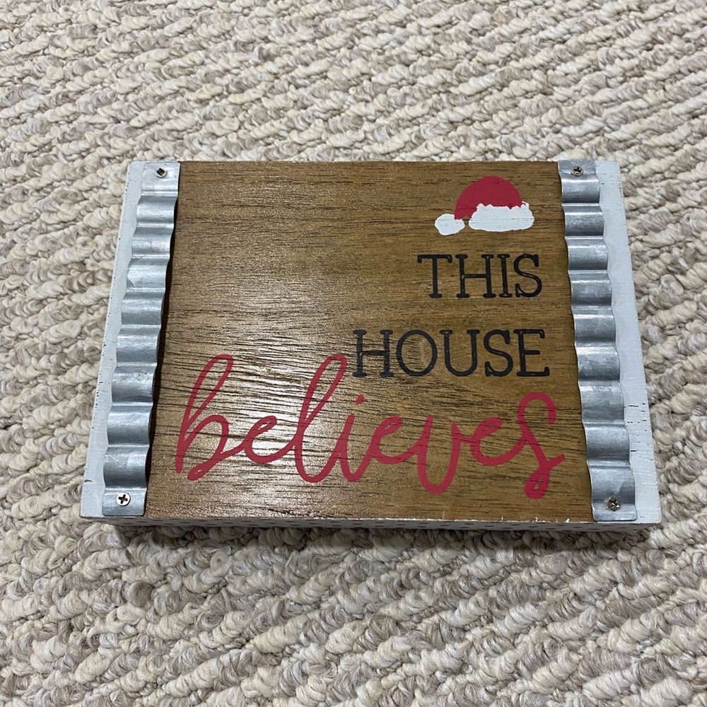 Small sign - “This house believes”